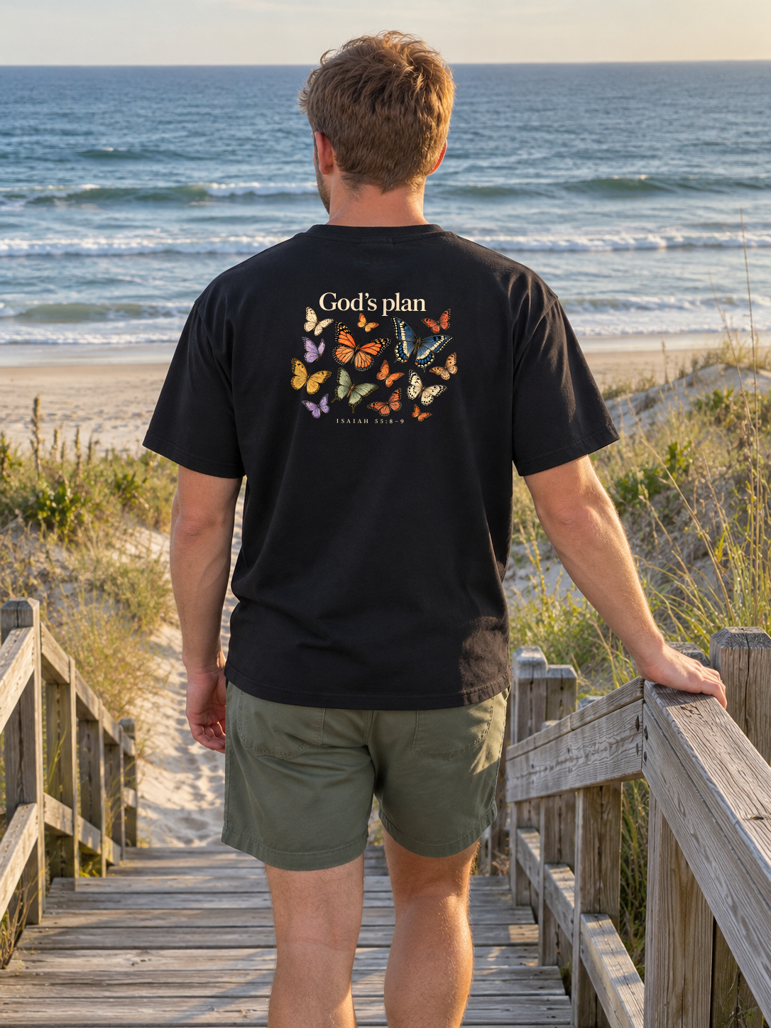 God’s Plan Tee back butterfly artwork on a man on beach access stairs
