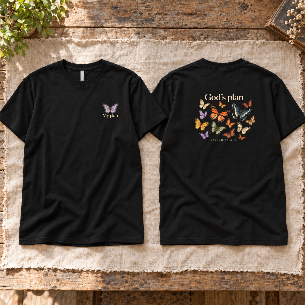 Black God’s Plan Tee front and back together on linen over a weathered wooden table