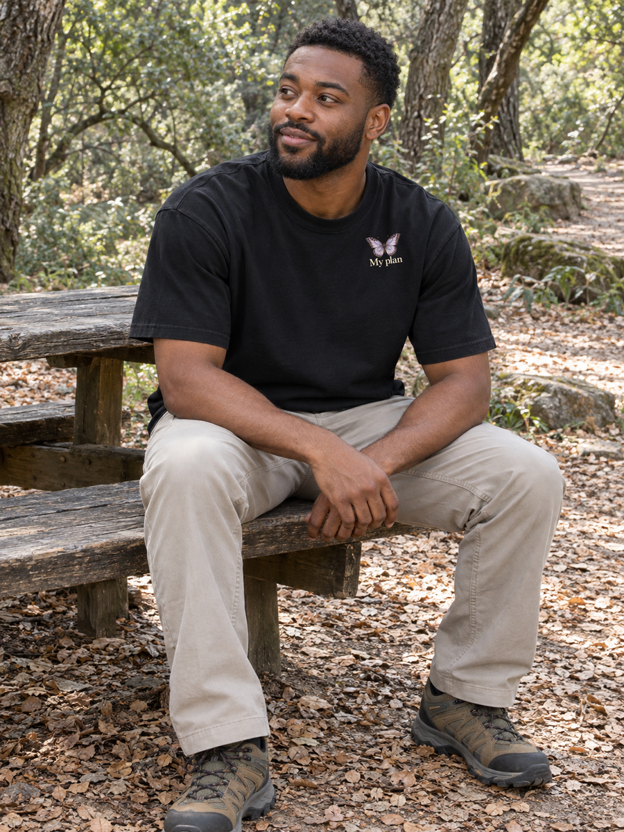 My plan butterfly chest print on a man seated on a woodland bench