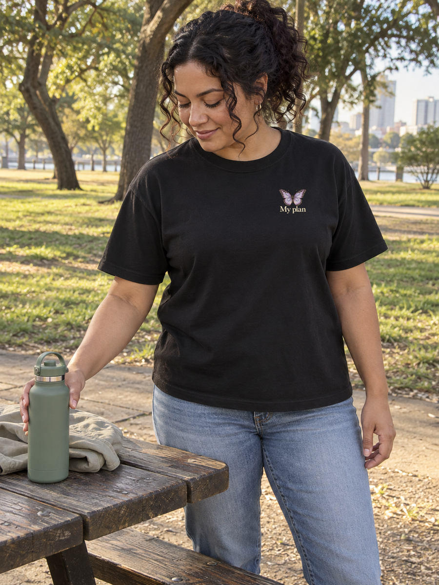 My plan chest butterfly on a black tee at a park picnic table