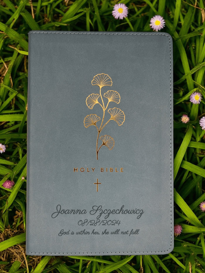Close-up of a gray Bible personalized with a name and date