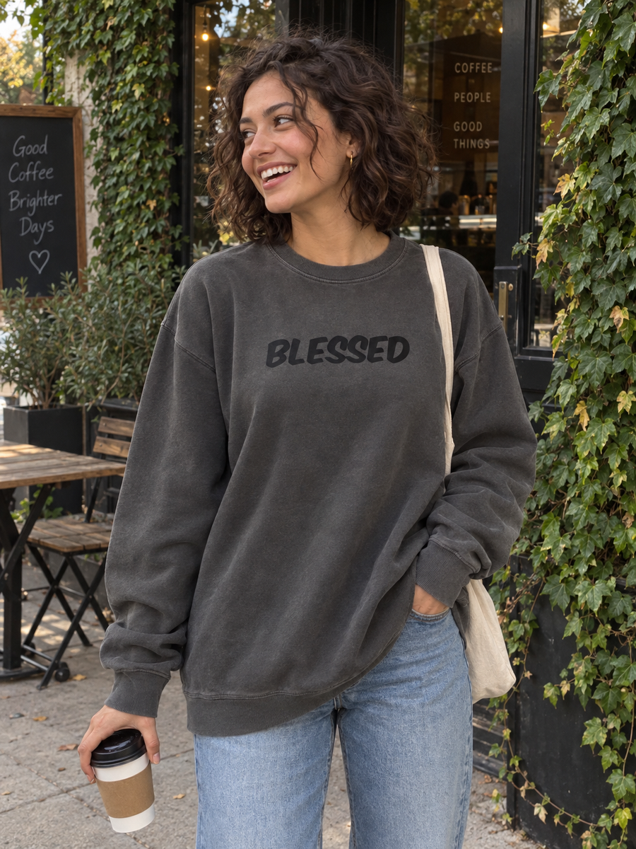Blessed Unisex Pigment-Dyed Crewneck Sweatshirt — Woman holding coffee outside leafy café