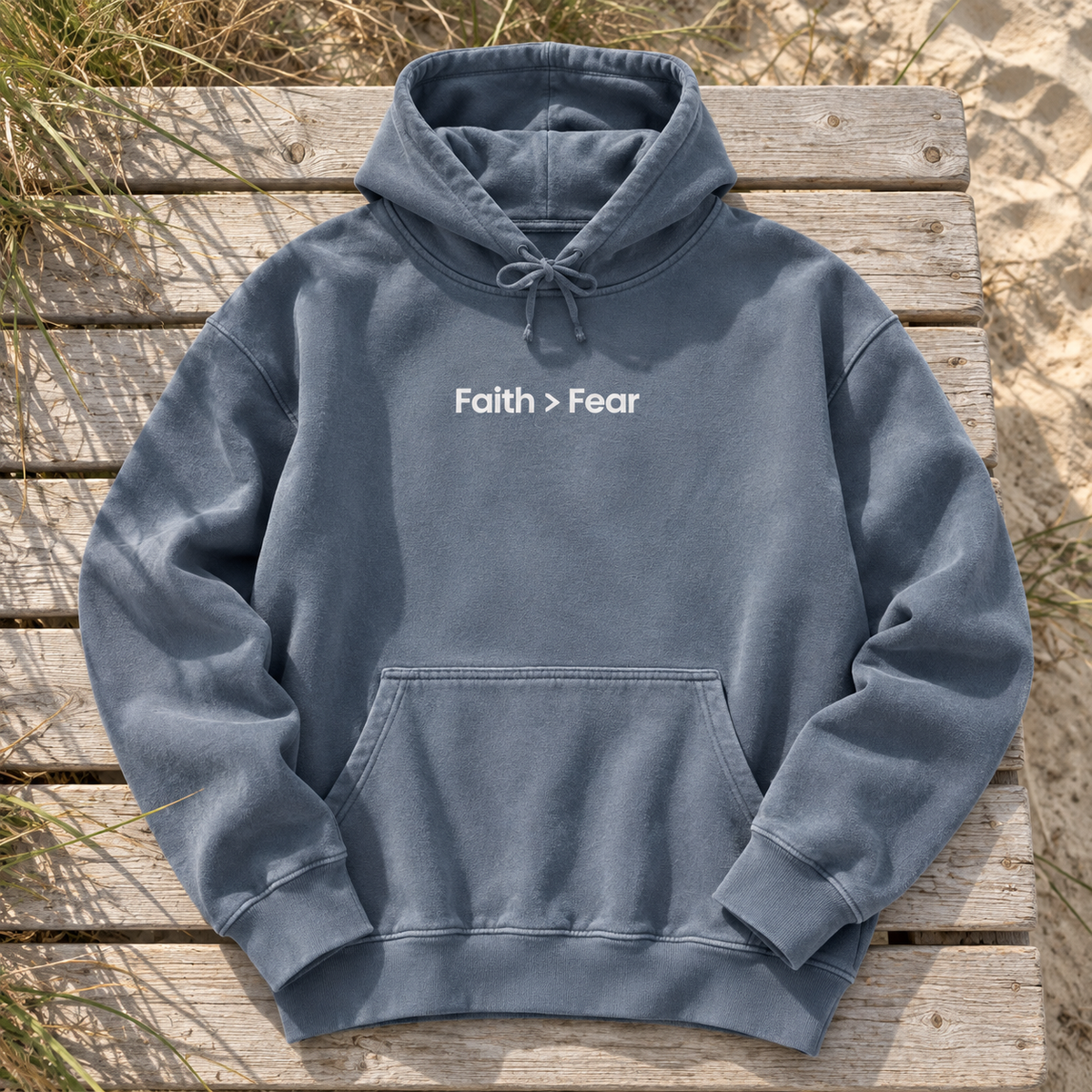 washed dusty blue hoodie with white Faith > Fear lettering centered chest — square editorial flat lay
