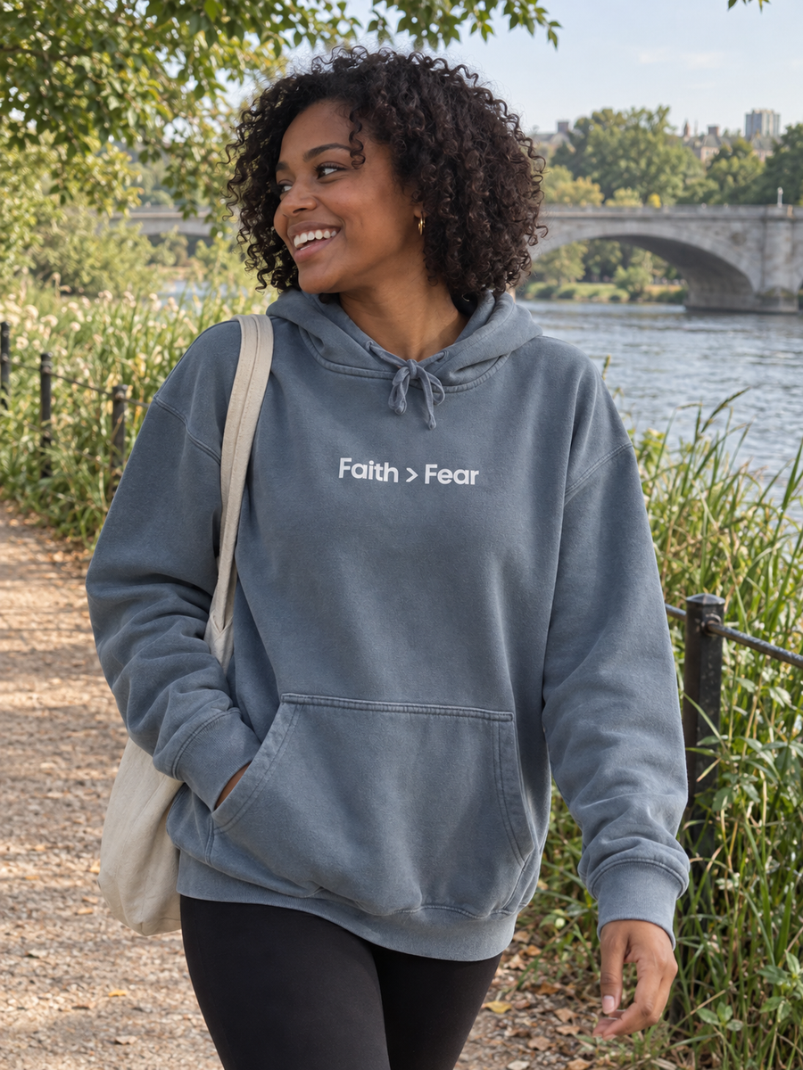 Faith > Fear Unisex Pigment-Dyed Hoodie Sweatshirt — Woman on riverside trail