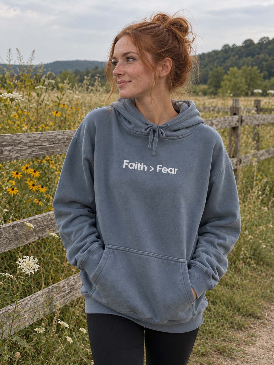 Faith > Fear Unisex Pigment-Dyed Hoodie Sweatshirt — Woman by meadow fence