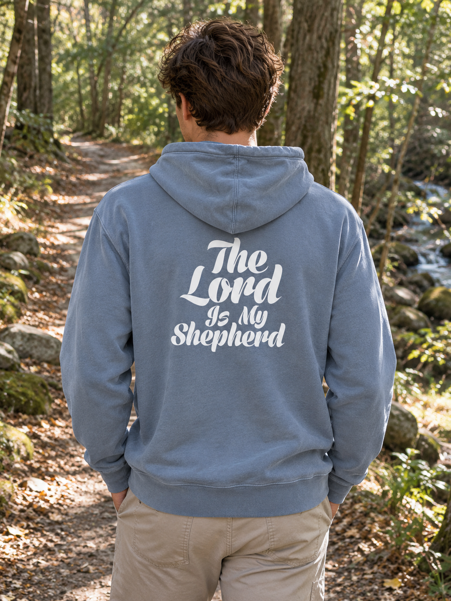Psalm 23:1 Unisex Pigment-Dyed Hoodie Sweatshirt — Man on woodland path, back print visible