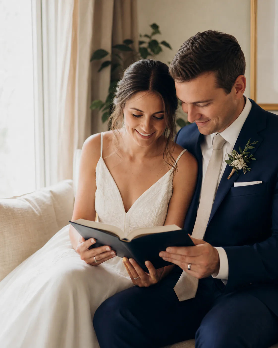 Newlywed couple reading a Bible together beside a window