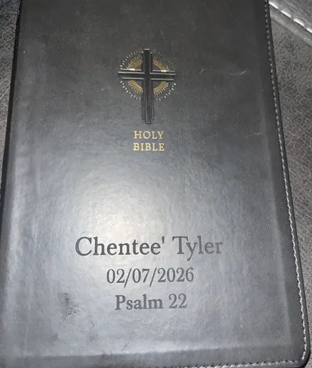 A customer’s black Bible personalized with a name, date, and verse