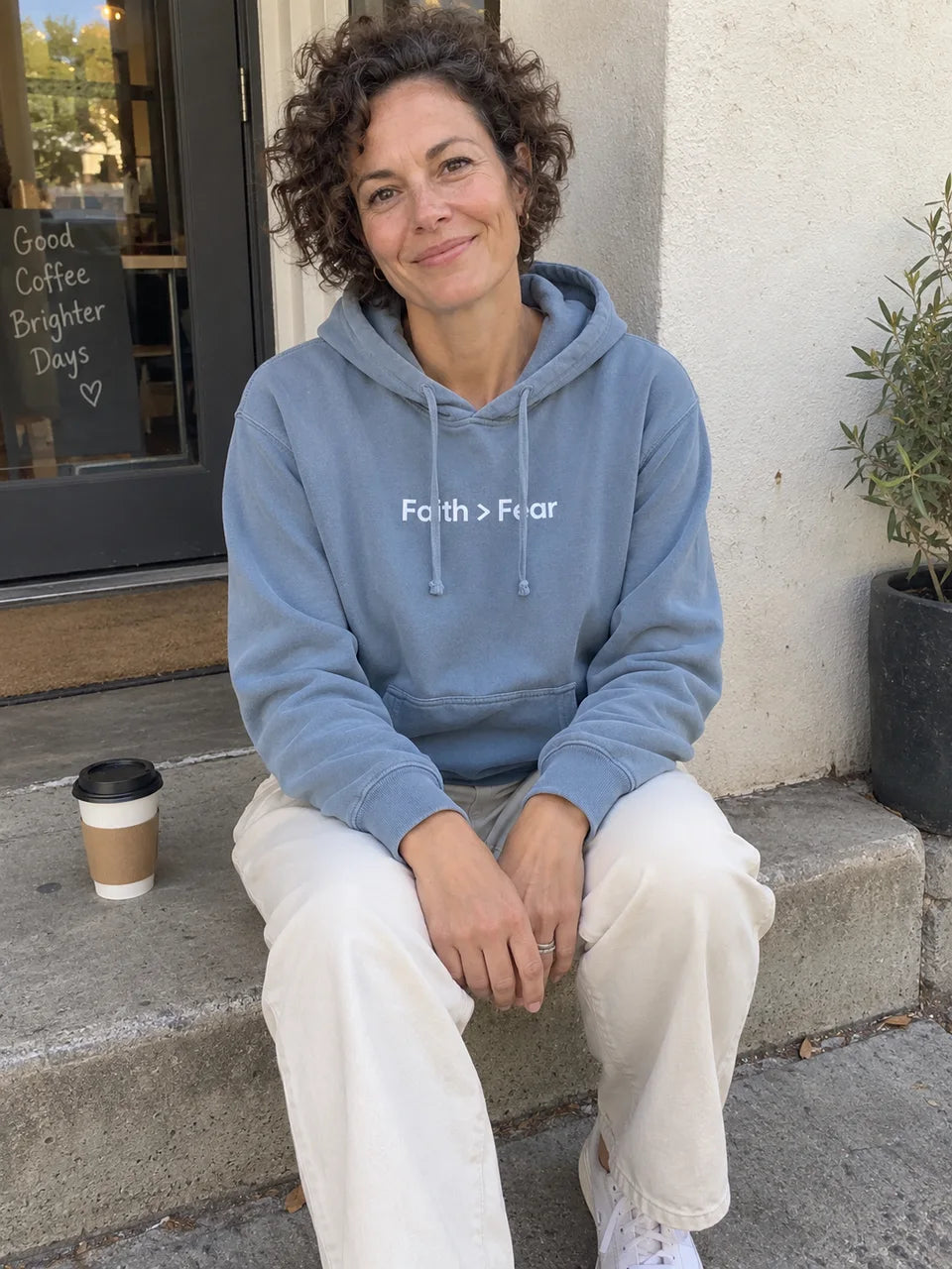 Dusty blue Faith greater than Fear hoodie on a coffee break