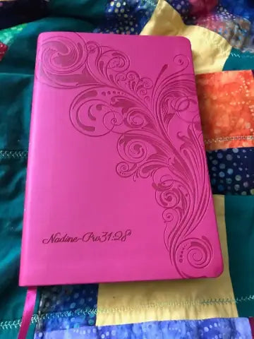 Actual customer photo of a pink Bible with floral design and existing name personalization