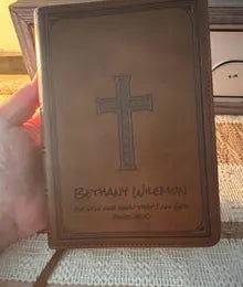 A brown cross Bible photographed by a customer