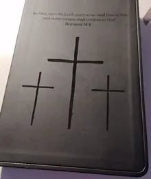 A customer’s black Bible with three crosses
